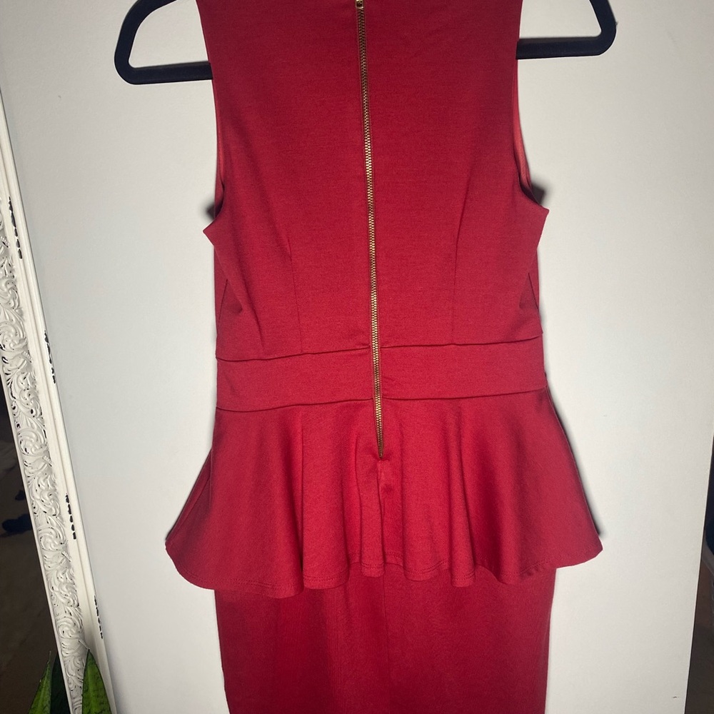 Tight fitted, red dress with ruffle.
